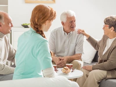 Residents engaging in conversation with staff