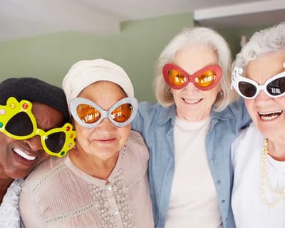 Residents enjoying a fun group activity with oversized glasses