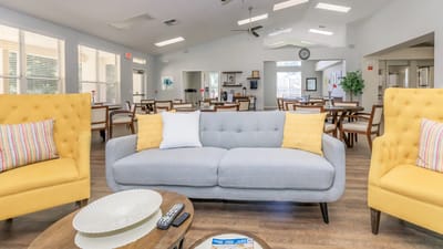 Bright common area with comfortable seating and dining space.