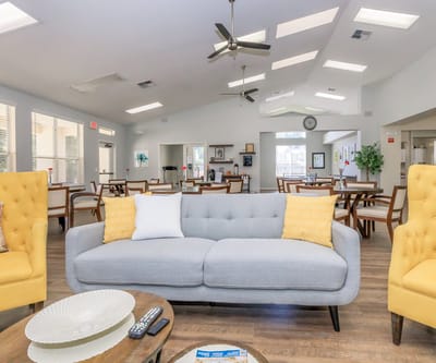 Bright common area with seating and large windows