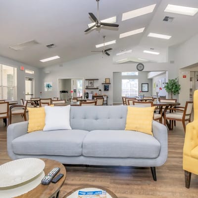 Bright common area with furniture and dining tables