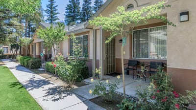 Attractive outdoor walkway with resident units and flower beds