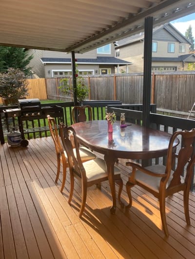 Outdoor dining area with wooden table and chairs