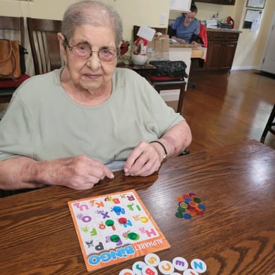Resident playing bingo in an activity room