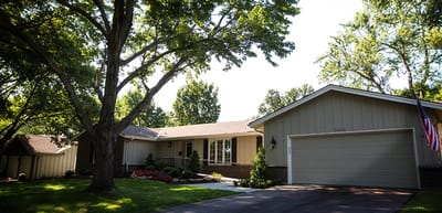 Exterior view of a senior living facility surrounded by trees