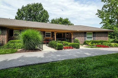 Exterior view of a senior care facility with landscaping
