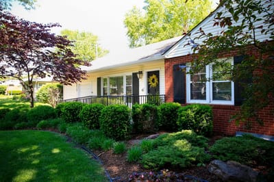 Exterior view of a senior care home with landscaping