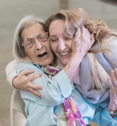 A joyful interaction between a resident and caregiver