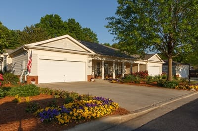 Exterior view of a assisted living facility with gardens