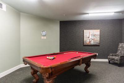Game room with a pool table and artwork