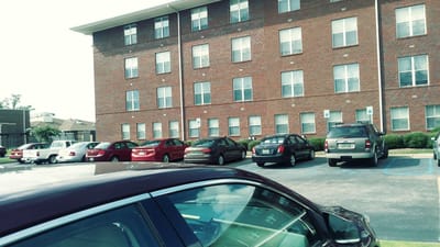 Exterior view of Villa Maria Apartments with parked cars