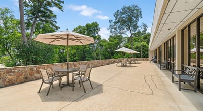 Outdoor patio area with tables and umbrellas
