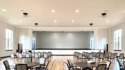 A spacious interior event room with seating