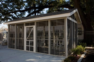 Screened outdoor seating area with rocking chairs