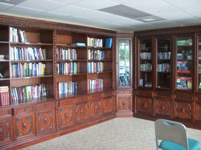 Interior view of a library with wooden shelves and books
