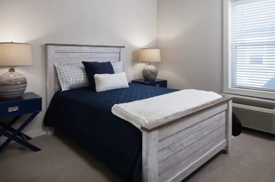 Cozy bedroom setup with lamps and bedding