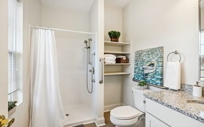Bright, modern bathroom with shower and amenities