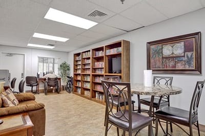 Common area with bookshelves and seating for residents