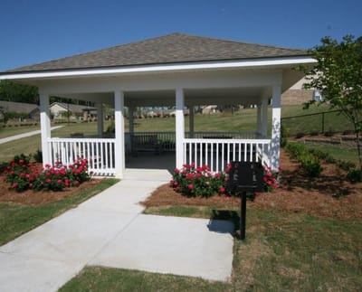 Outdoor gazebo with flowers and seating area