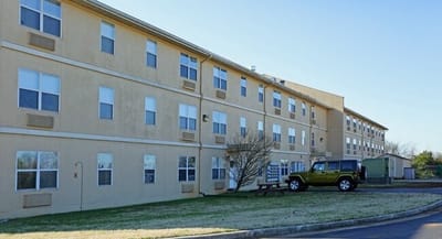 Exterior view of the Dublin Village building with a parked vehicle