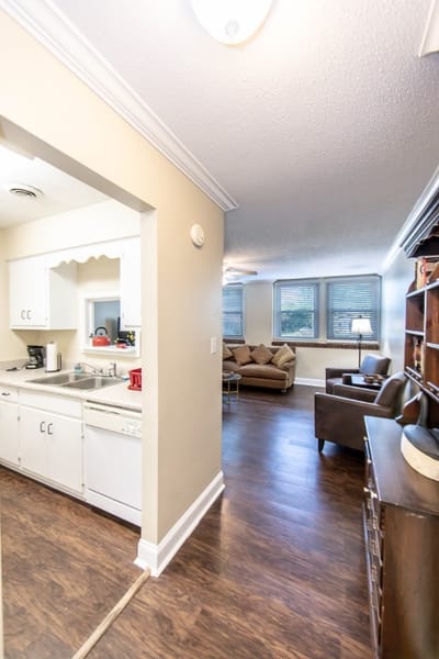 A cozy resident room with a living area and kitchenette