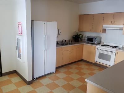 Bright kitchen area with appliances and countertop