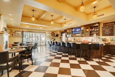 Well-lit common area with seating and coffee bar
