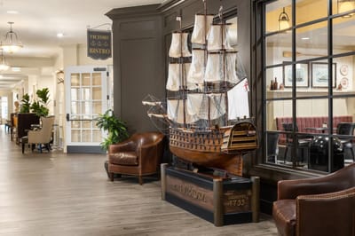 Interior view of a common area featuring a model ship