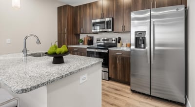 Modern kitchen with stainless steel appliances and granite countertops