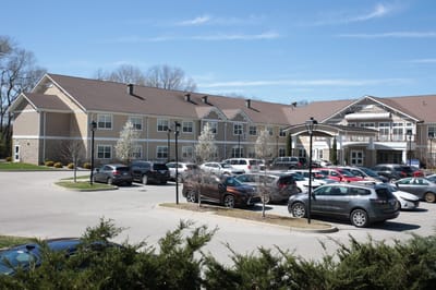 Exterior view of The Springs at Stony Brook with garden and parking lot