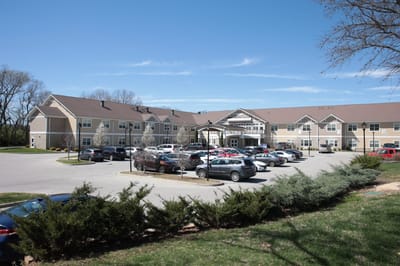 Exterior view of The Springs at Stony Brook with parking area
