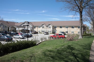 Exterior view of a senior living facility with parking