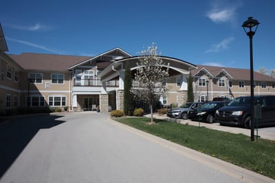 Exterior view of assisted living facility with parking area