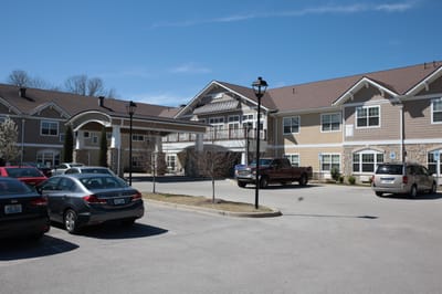 Exterior view of The Springs at Stony Brook with parked cars