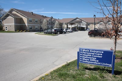 Exterior view of The Springs at Stony Brook with a sign.