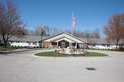 Exterior view of a senior living facility with landscaping