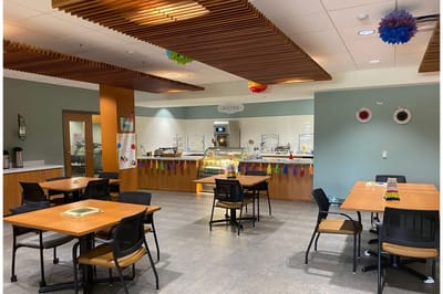 Inside view of a dining area with tables and food service