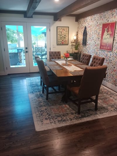 Cozy dining area with floral wallpaper and a table set for meals