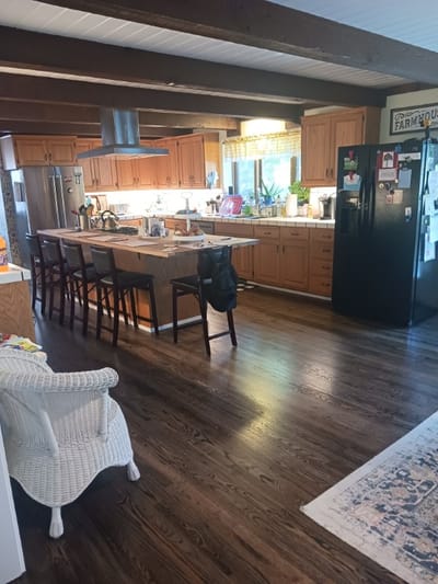 Bright kitchen interior with wooden cabinets and dining area