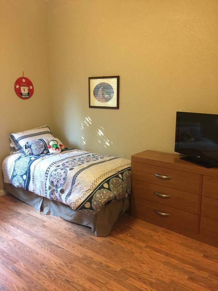 Cozy private resident room with bed and TV