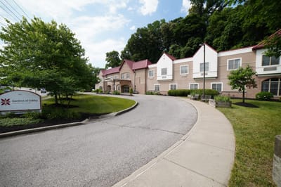 Exterior view of Gardens of Oakley with landscaped driveway