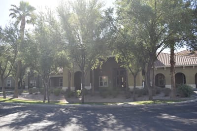 Exterior view of a senior living facility surrounded by trees