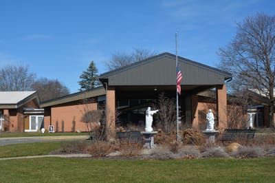 Exterior view of St. Ann's Home with garden