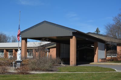 Entrance of St. Ann's Home facility with flag