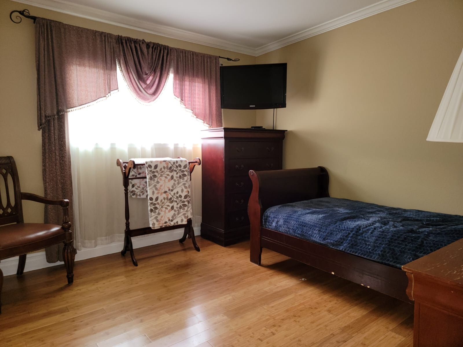 Cozy resident room with a bed and chair