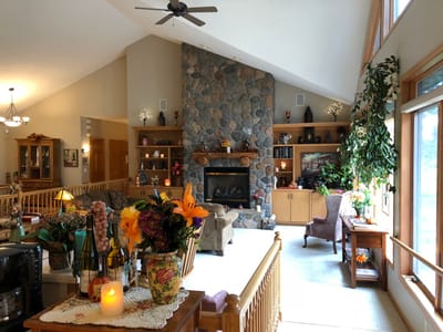 Cozy common area with a stone fireplace and floral decor
