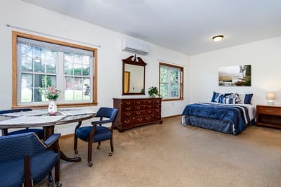 A well-furnished resident room in a senior living facility