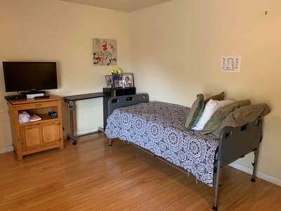 Private resident room with a bed and TV