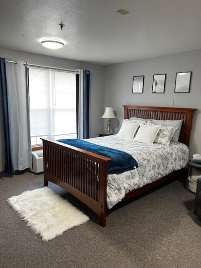 Cozy resident room with a large bed and natural light