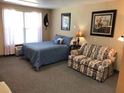 Spacious interior room with a bed and a couch